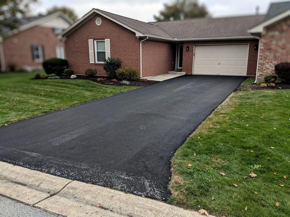 Freshly paved asphalt driveway at a Louisville, KY home